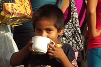 Son of cocoa farmer enjoying a chocolate drink